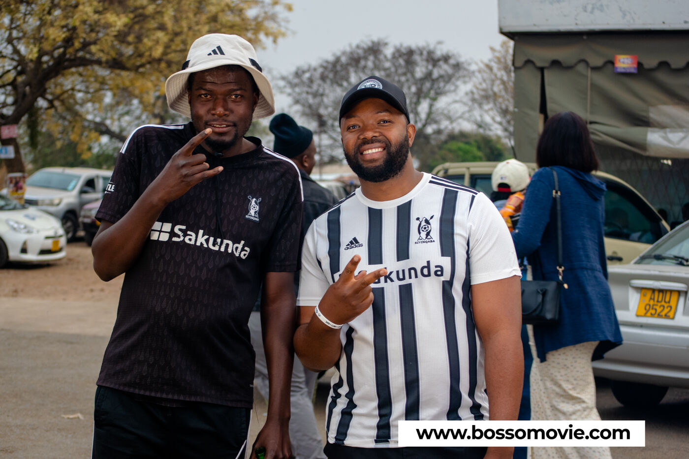 Two fans in Highlanders jerseys posing on the street