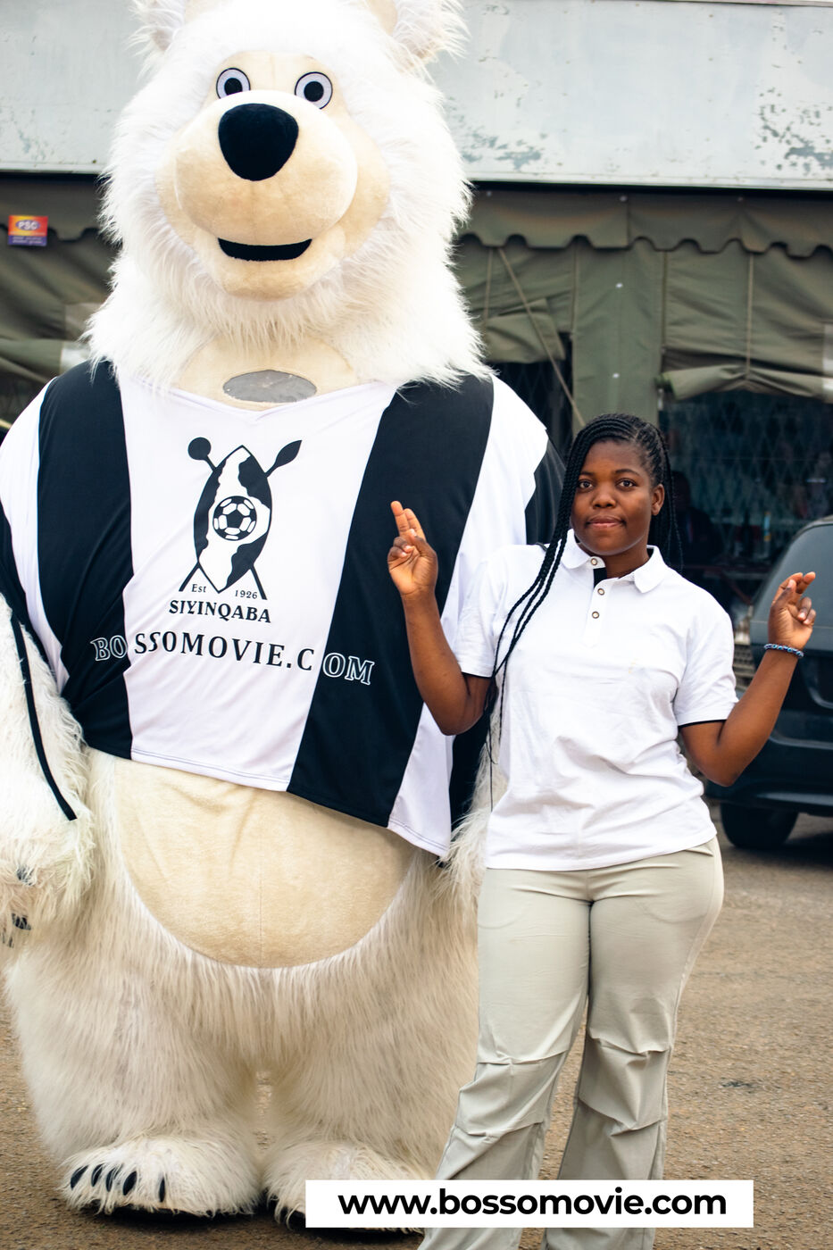 The Bosso Movie mascot posing with a fan